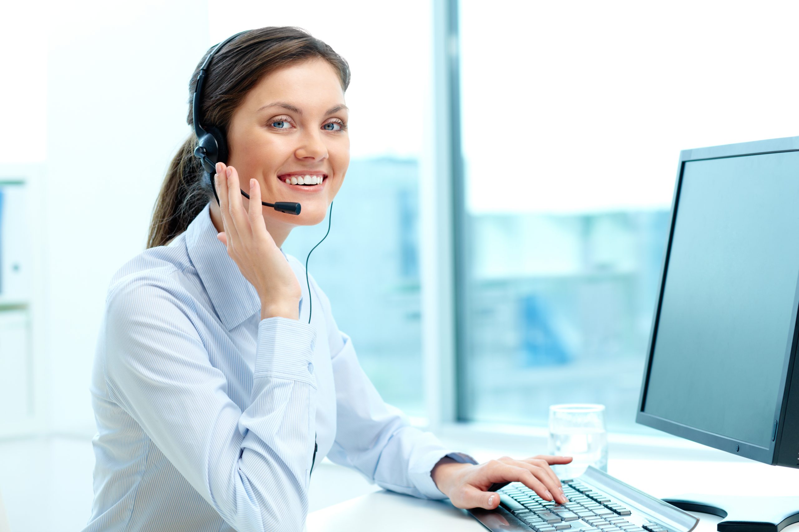 Live operator with headset looking at camera with friendly smile