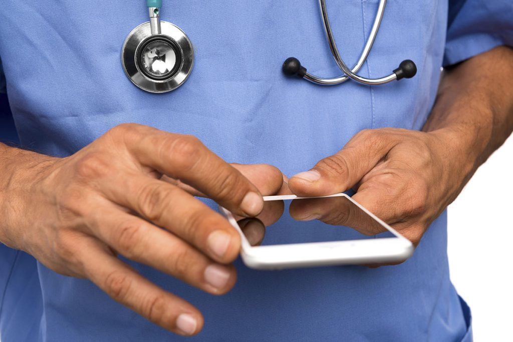 Doctor scrolling on smartphone-image