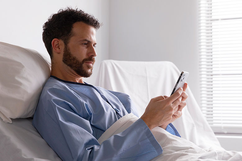 Male-patient-bed-hospital-on-phone